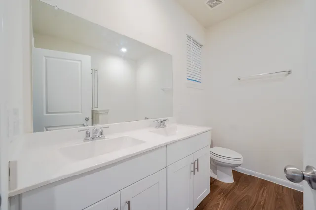 a bathroom with a sink toilet and a mirror