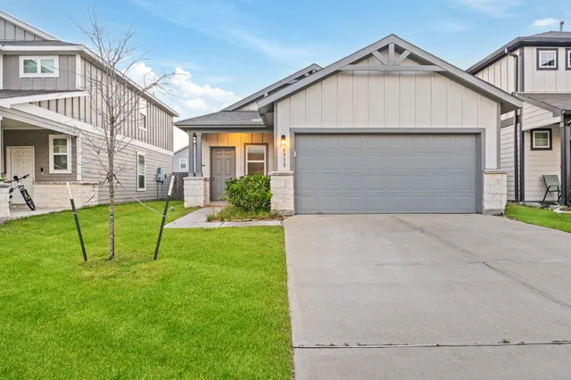 a view of a white house with a yard and table and chairs