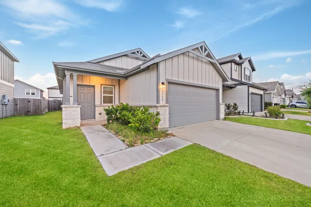 a view of a house with a yard and a garden