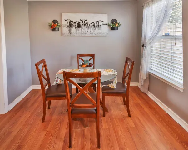 a dining room with furniture wooden floor and a rug