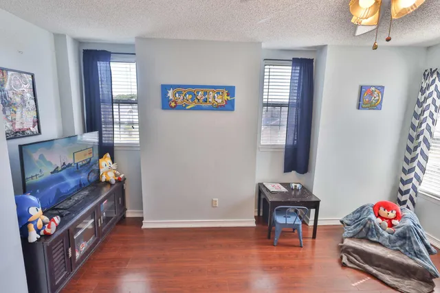 a bedroom with furniture and a wooden floor