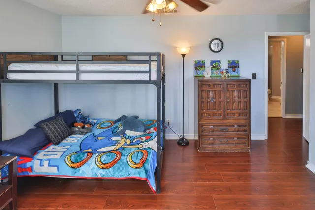 a bedroom with a bed and wooden floor