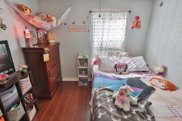 a bedroom with furniture and a flat screen tv