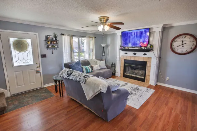 a living room with furniture fireplace and window
