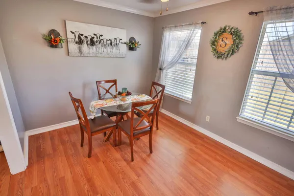 a dining room with furniture a rug and wooden floor