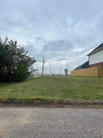 a view of a field with an trees in the background