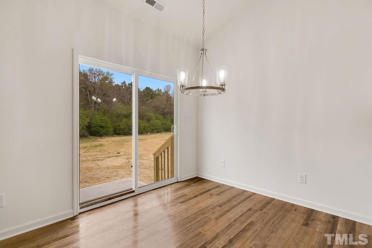 4066 Needham Road Bailey, NC 27807 - Photo 12 of 25 a view of empty room with wooden floor and fan
