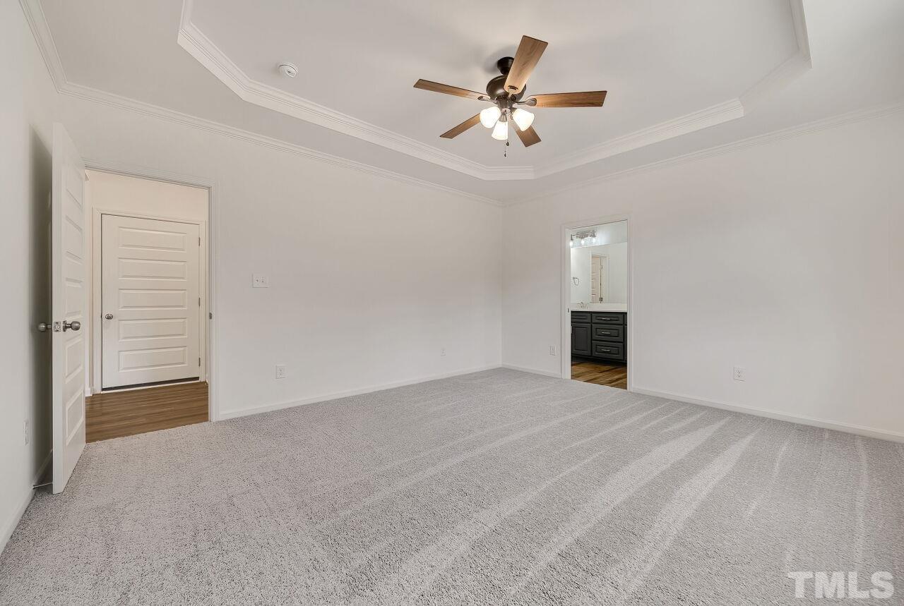 4066 Needham Road Bailey, NC 27807 - Photo 13 of 25 an empty room with chandelier fan and windows