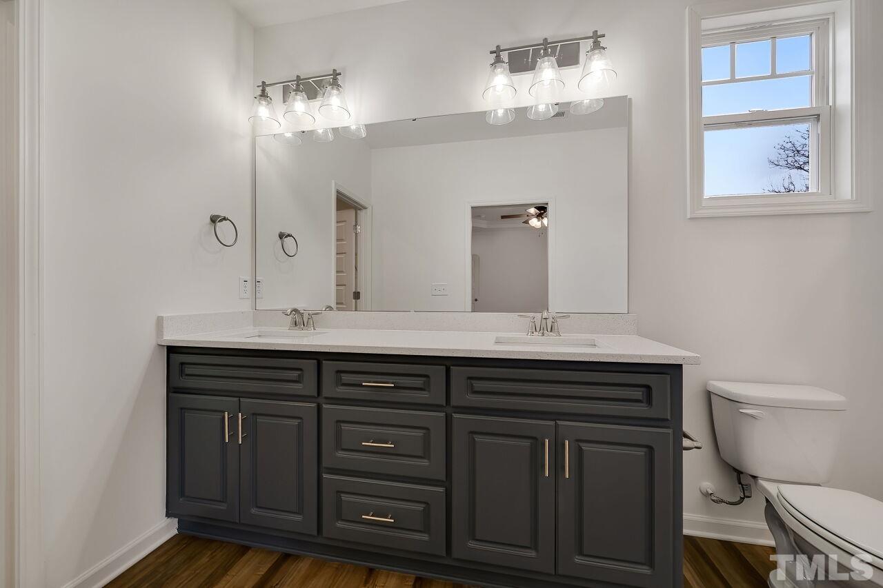 4066 Needham Road Bailey, NC 27807 - Photo 14 of 25 a bathroom with a granite countertop sink a toilet and a mirror