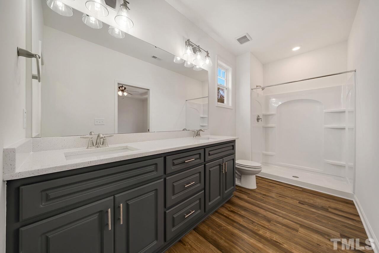 4066 Needham Road Bailey, NC 27807 - Photo 5 of 25 a bath room with a sink double vanity granite tub shower and a mirror
