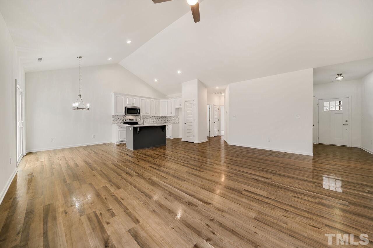 4066 Needham Road Bailey, NC 27807 - Photo 7 of 25 a view of empty room with wooden floor and kitchen