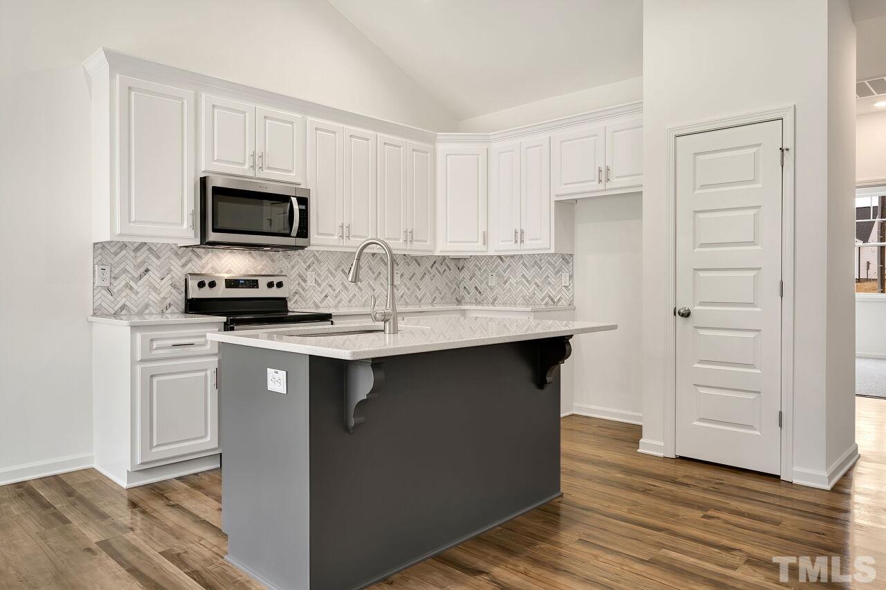 4066 Needham Road Bailey, NC 27807 - Photo 10 of 25 a kitchen with stainless steel appliances a sink stove and refrigerator