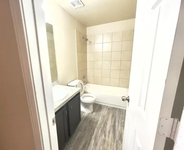 a bathroom with a sink a toilet and tub