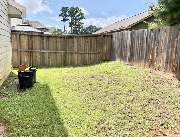 a backyard of a house with potted plants