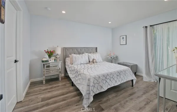 a bedroom with a large bed and a window