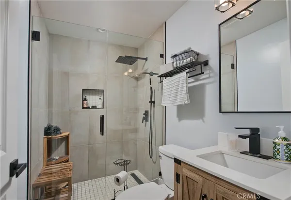 a bedroom with furniture and a flat screen tv