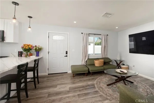 a living room with furniture and kitchen view