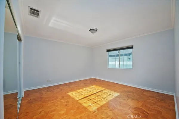 a view of walk in closet with empty racks