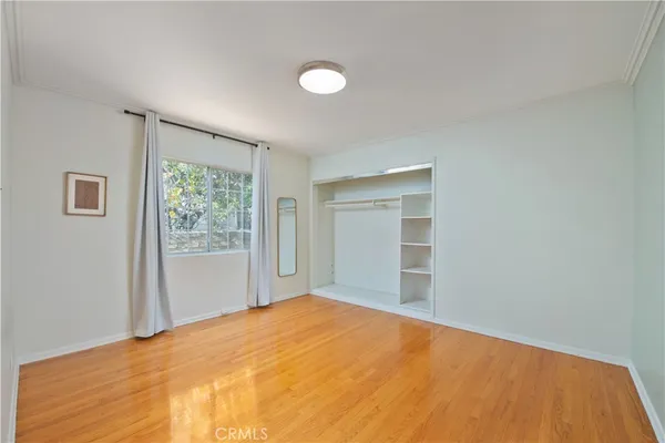 a view of an empty room with a fireplace and a window