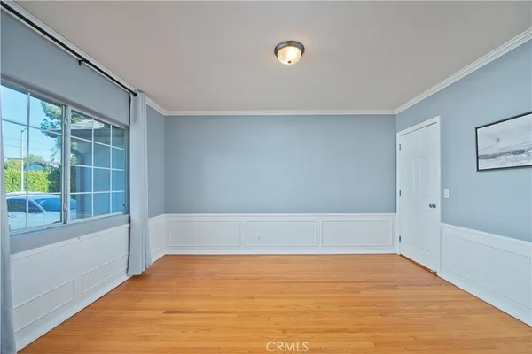 a large kitchen with a stove a sink dishwasher a refrigerator and a fireplace with wooden floor