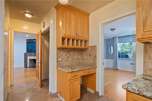 a view of kitchen with stainless steel appliances granite countertop a stove and a refrigerator