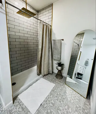 a bathroom with a shower and a tub