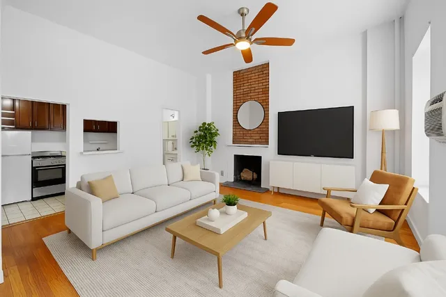 a living room with furniture a fireplace and a flat screen tv