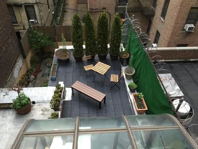 a kitchen with stainless steel appliances granite countertop a sink a stove a refrigerator with grey cabinets