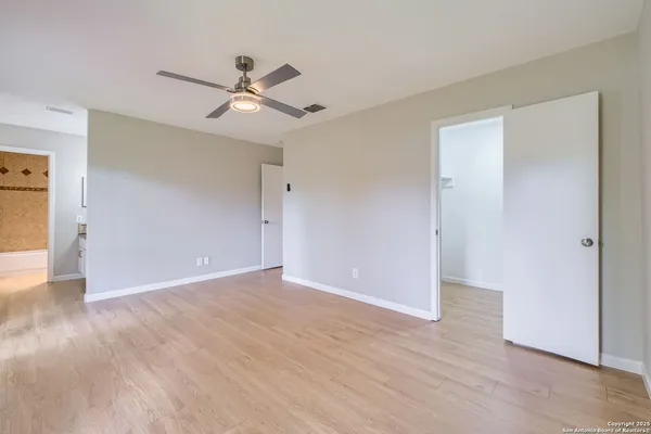 a view of an empty room with wooden floor
