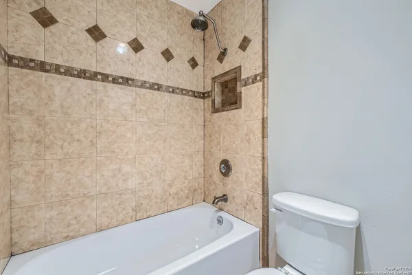a bathroom with a bathtub and a toilet