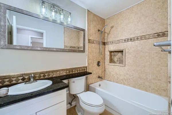 a bathroom with a sink a toilet and a bathtub