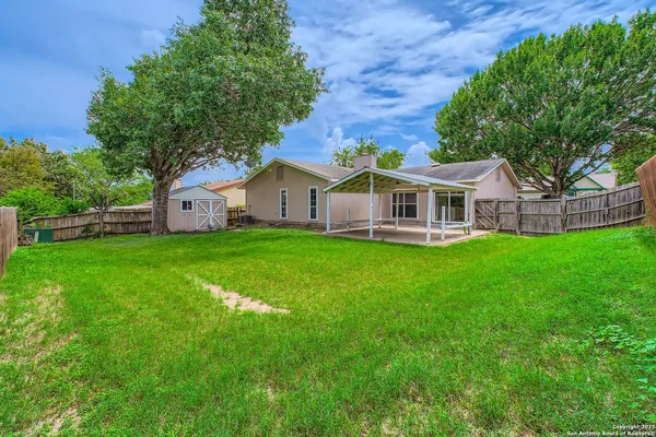 a view of a house with a deck and a big yard