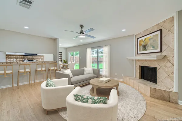 a living room with furniture and a fireplace