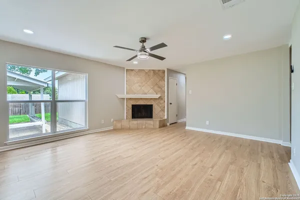 wooden floor in an empty room with a window