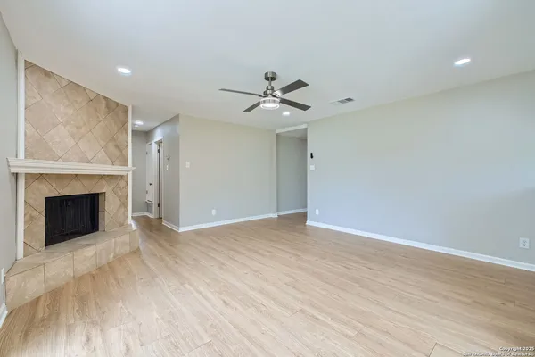 a view of an empty room with a fireplace