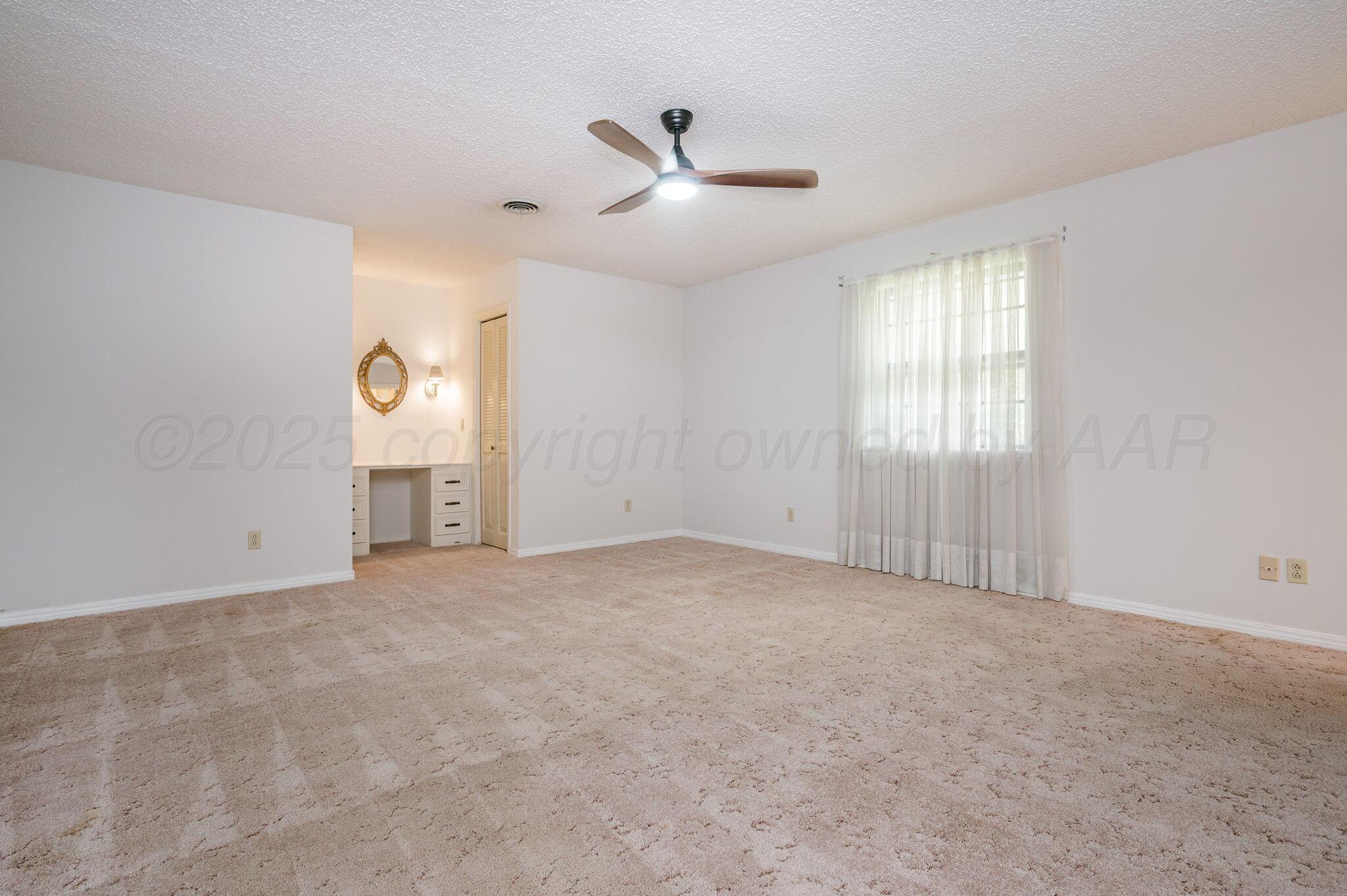 7830 Canode Drive Amarillo, TX 79121 - Photo 17 of 29 wooden floor in an empty room with a window
