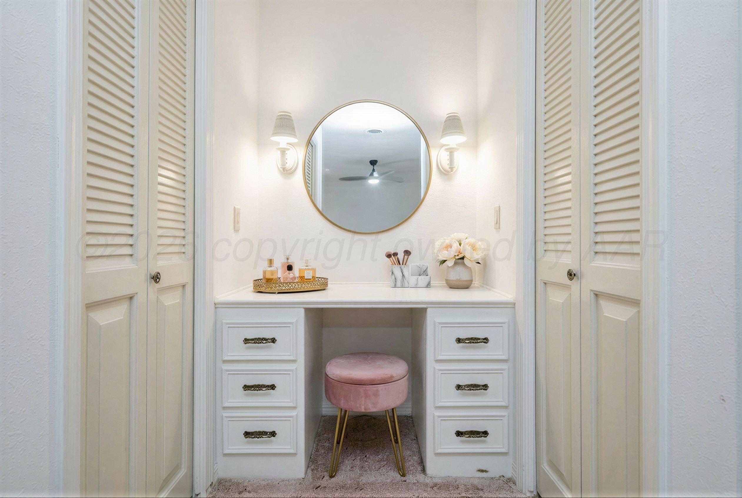 7830 Canode Drive Amarillo, TX 79121 - Photo 19 of 29 a bathroom with a toilet a sink and a mirror