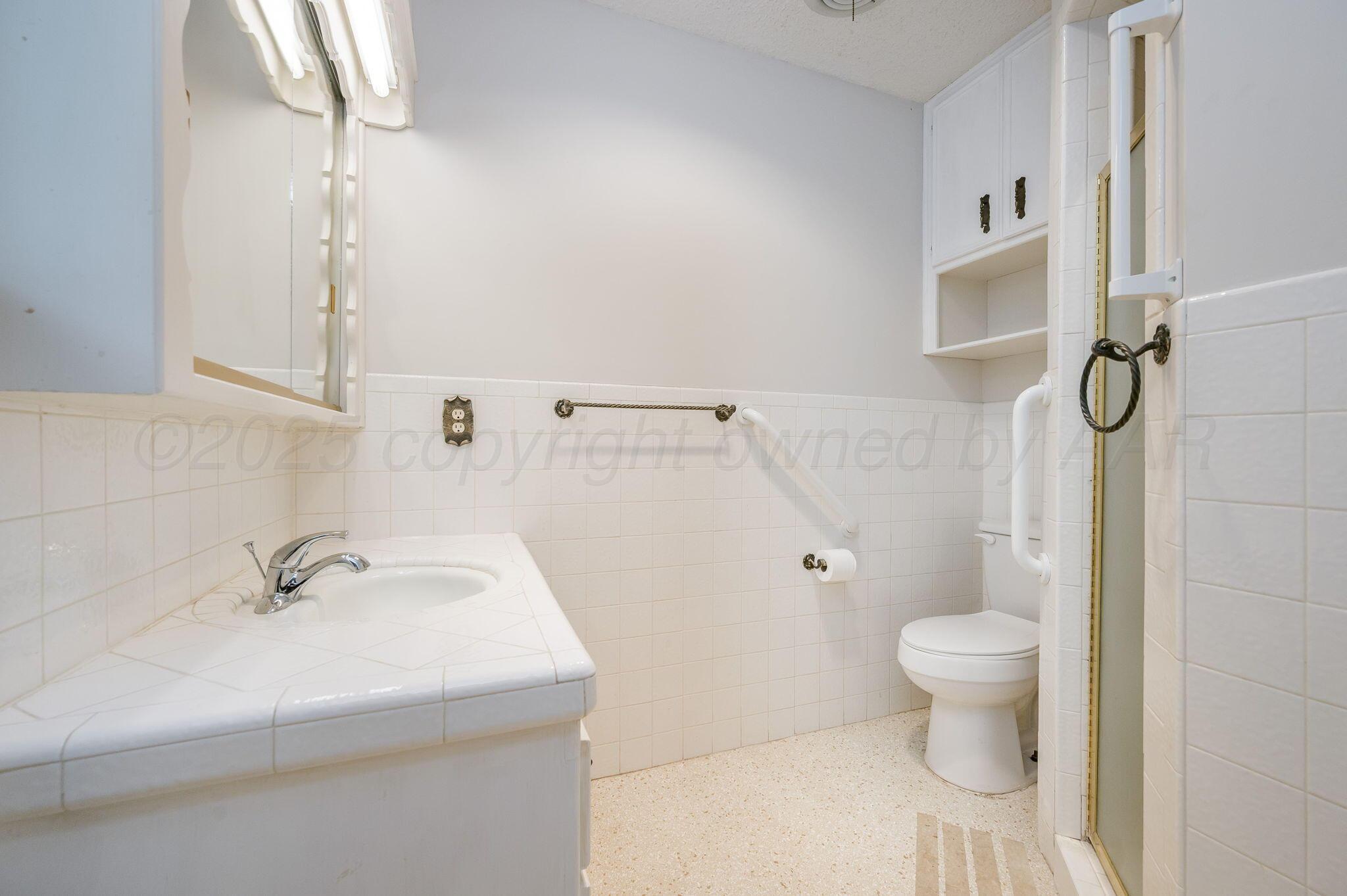 7830 Canode Drive Amarillo, TX 79121 - Photo 21 of 29 a bathroom with a sink toilet and shower