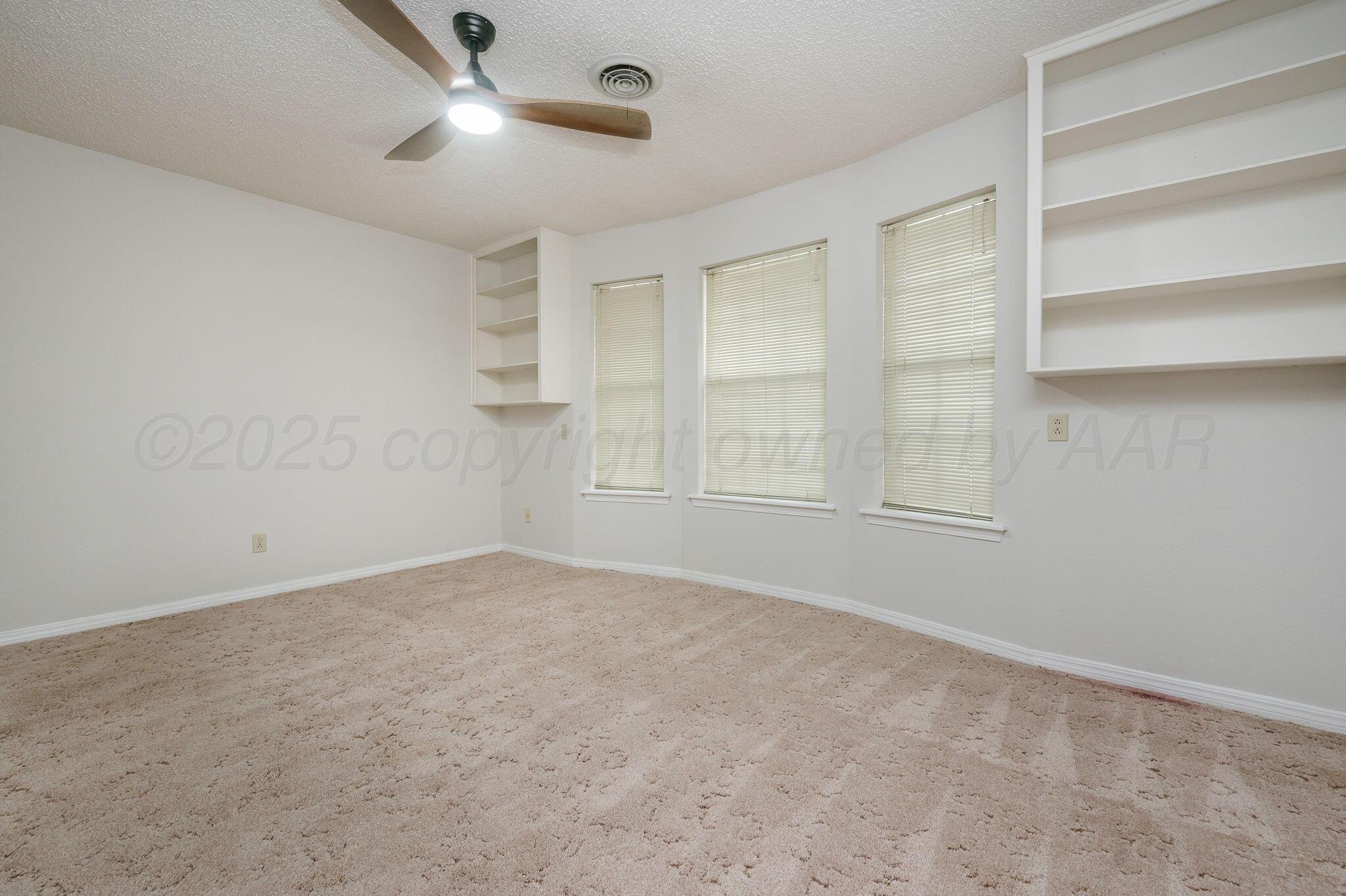 7830 Canode Drive Amarillo, TX 79121 - Photo 27 of 29 an empty room with windows and fan