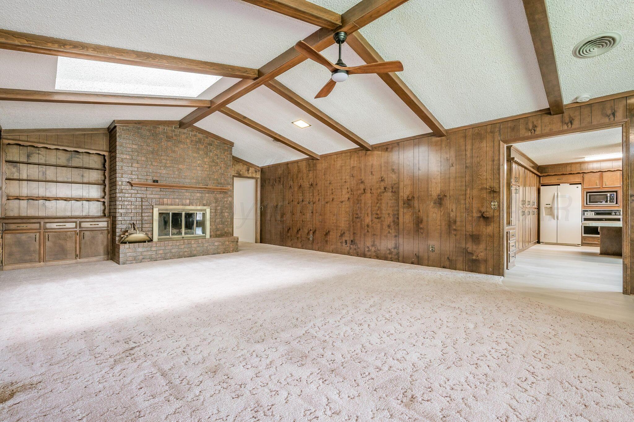 7830 Canode Drive Amarillo, TX 79121 - Photo 6 of 29 a view of empty room with a fireplace and windows