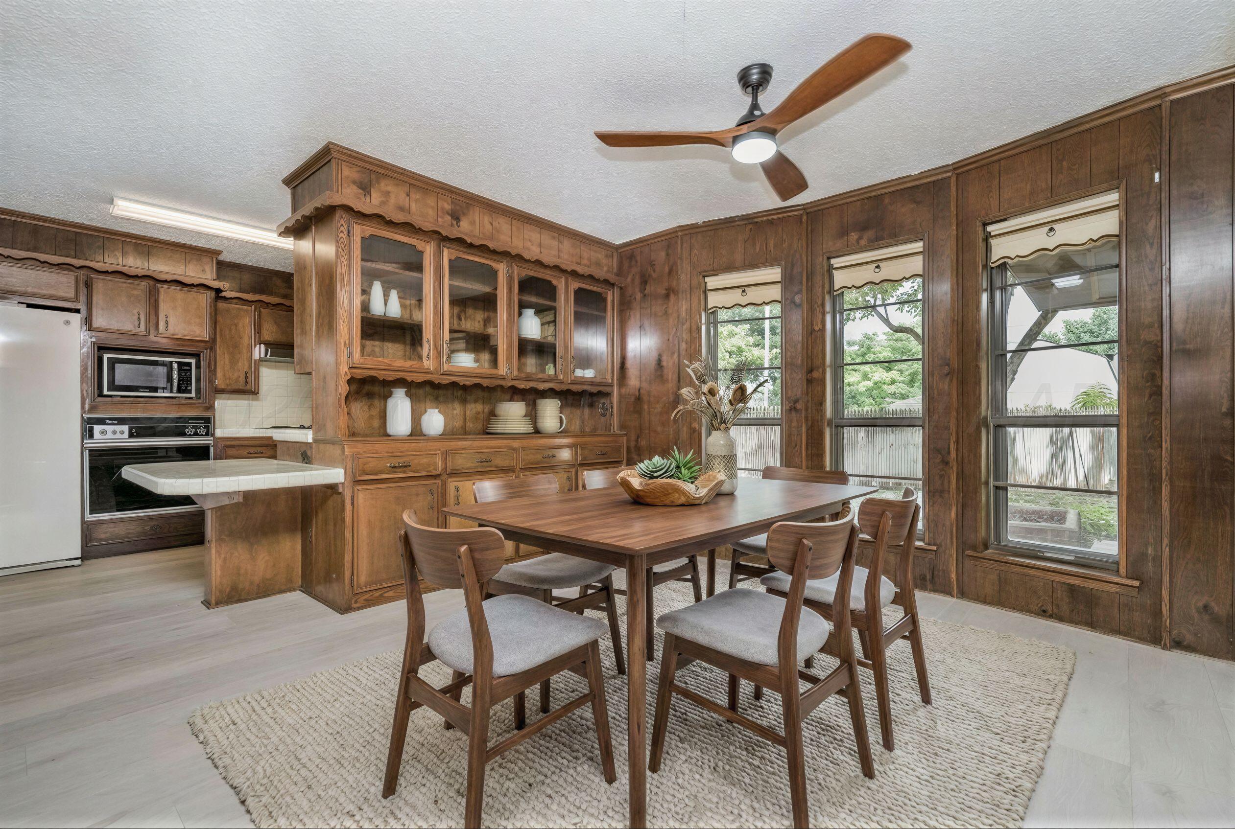 7830 Canode Drive Amarillo, TX 79121 - Photo 7 of 29 a dinning table and chairs in a open kitchen