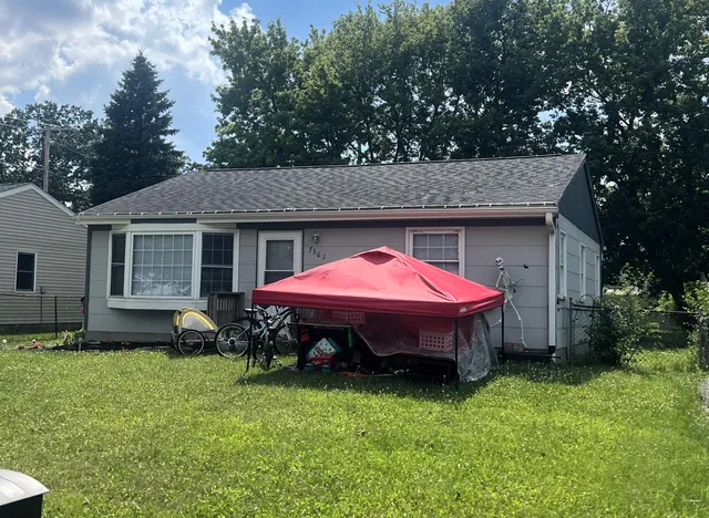 a front view of a house with a garden and porch