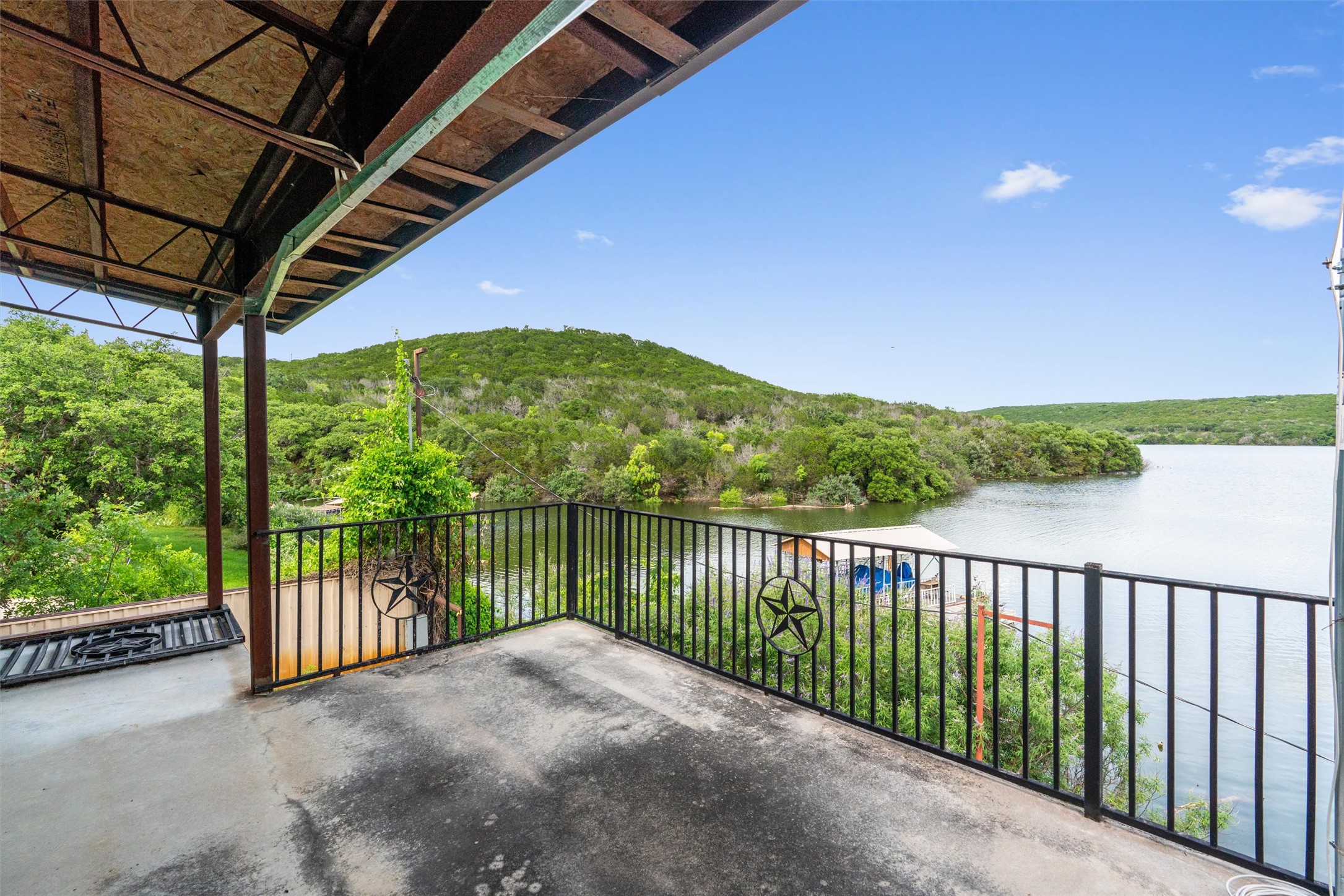 325 Eagle Rest Burnet, TX 78611 - Photo 28 of 40 Relax on the covered balcony, overlooking serene waters and verdant hillsides.