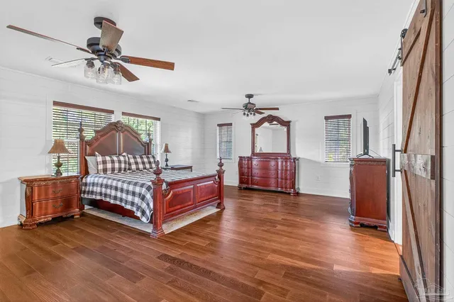 a view of an empty room with a window and a ceiling fan