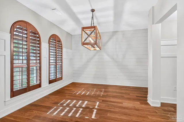 a bedroom with a bed dresser and a window