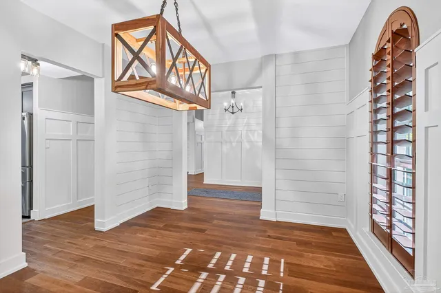 a bedroom with furniture and a wooden floor