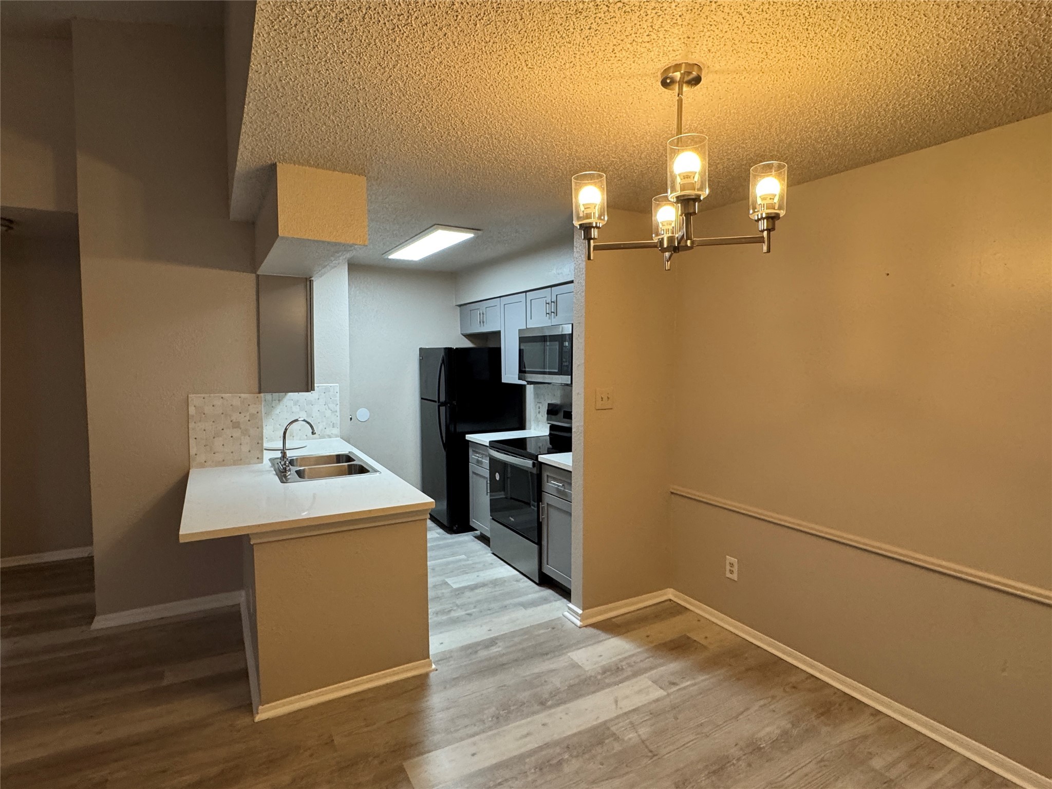 10101 South Gessner Road, Unit 305 Houston, TX 77071 - Photo 14 of 18 a view of a kitchen with a sink stainless steel appliances and cabinets
