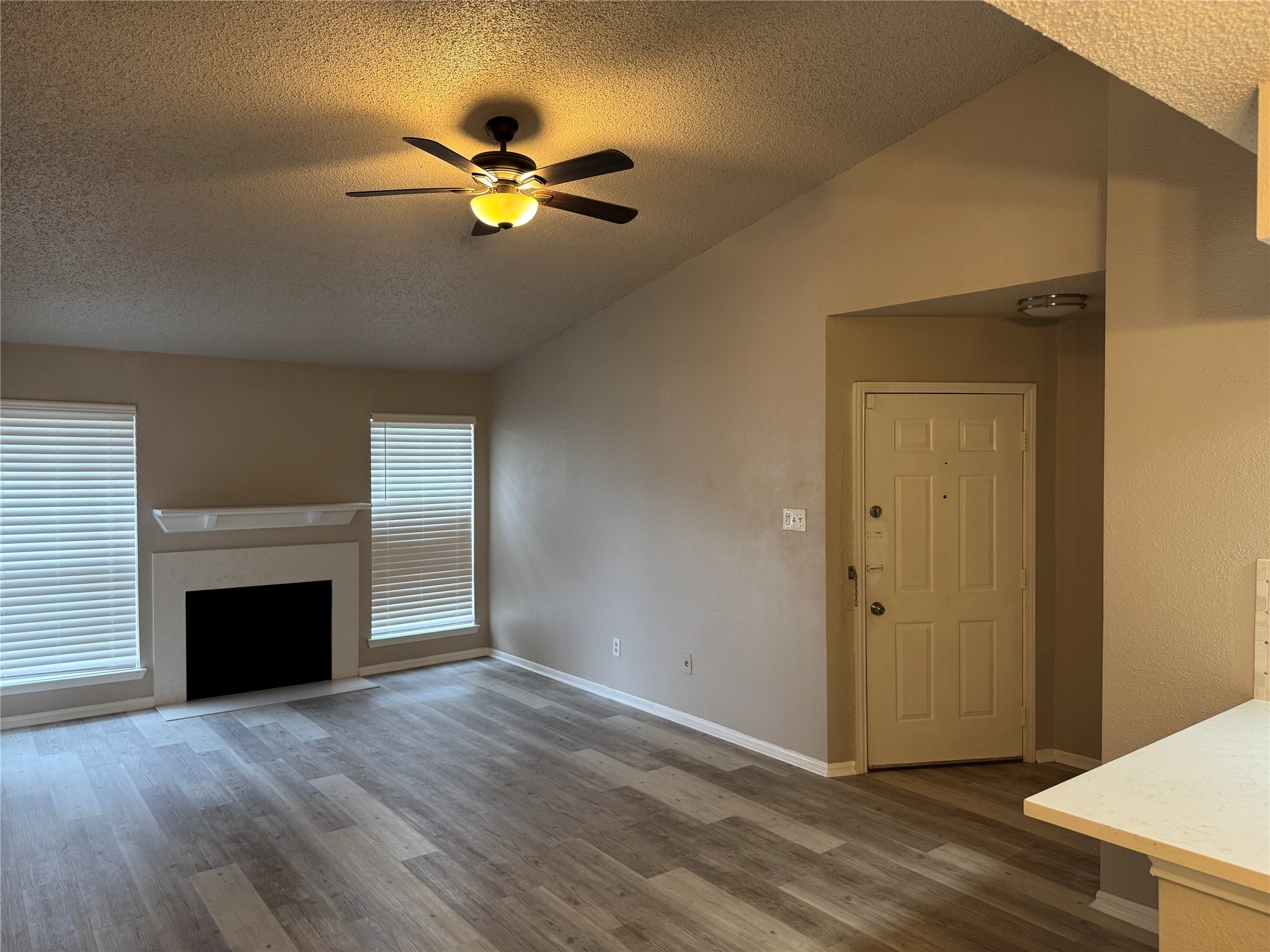 10101 South Gessner Road, Unit 305 Houston, TX 77071 - Photo 16 of 18 a view of an empty room with wooden floor and a fireplace