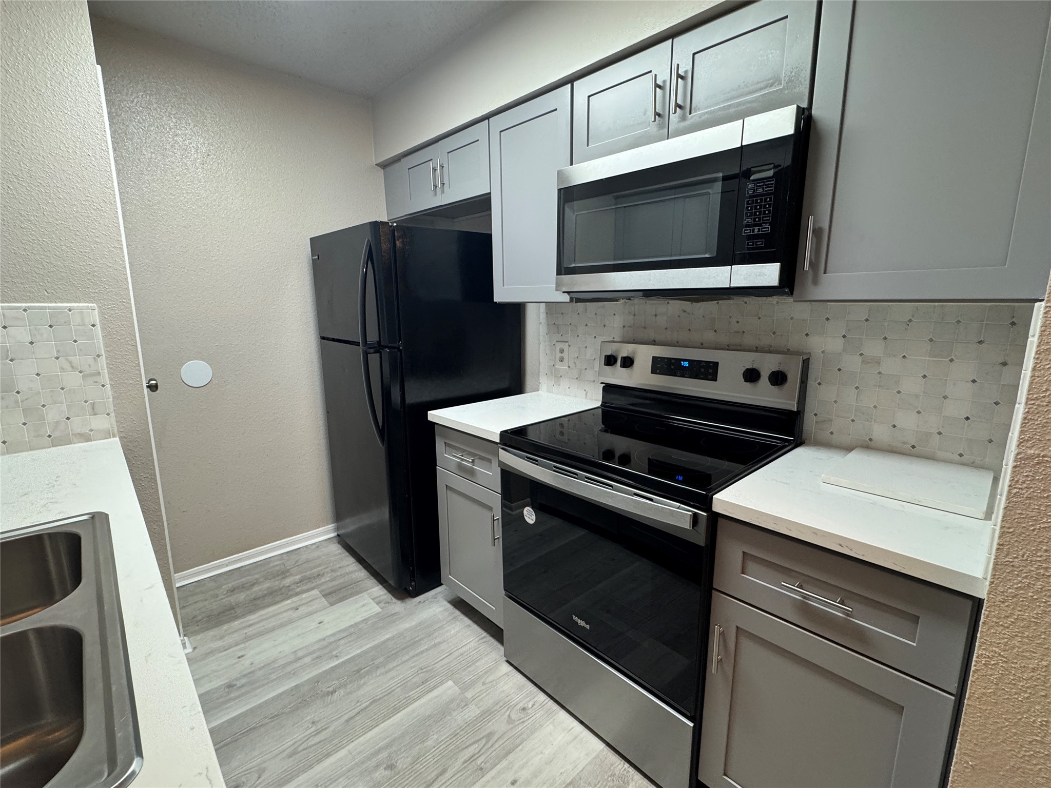 10101 South Gessner Road, Unit 305 Houston, TX 77071 - Photo 5 of 18 a kitchen with stainless steel appliances a stove microwave and refrigerator