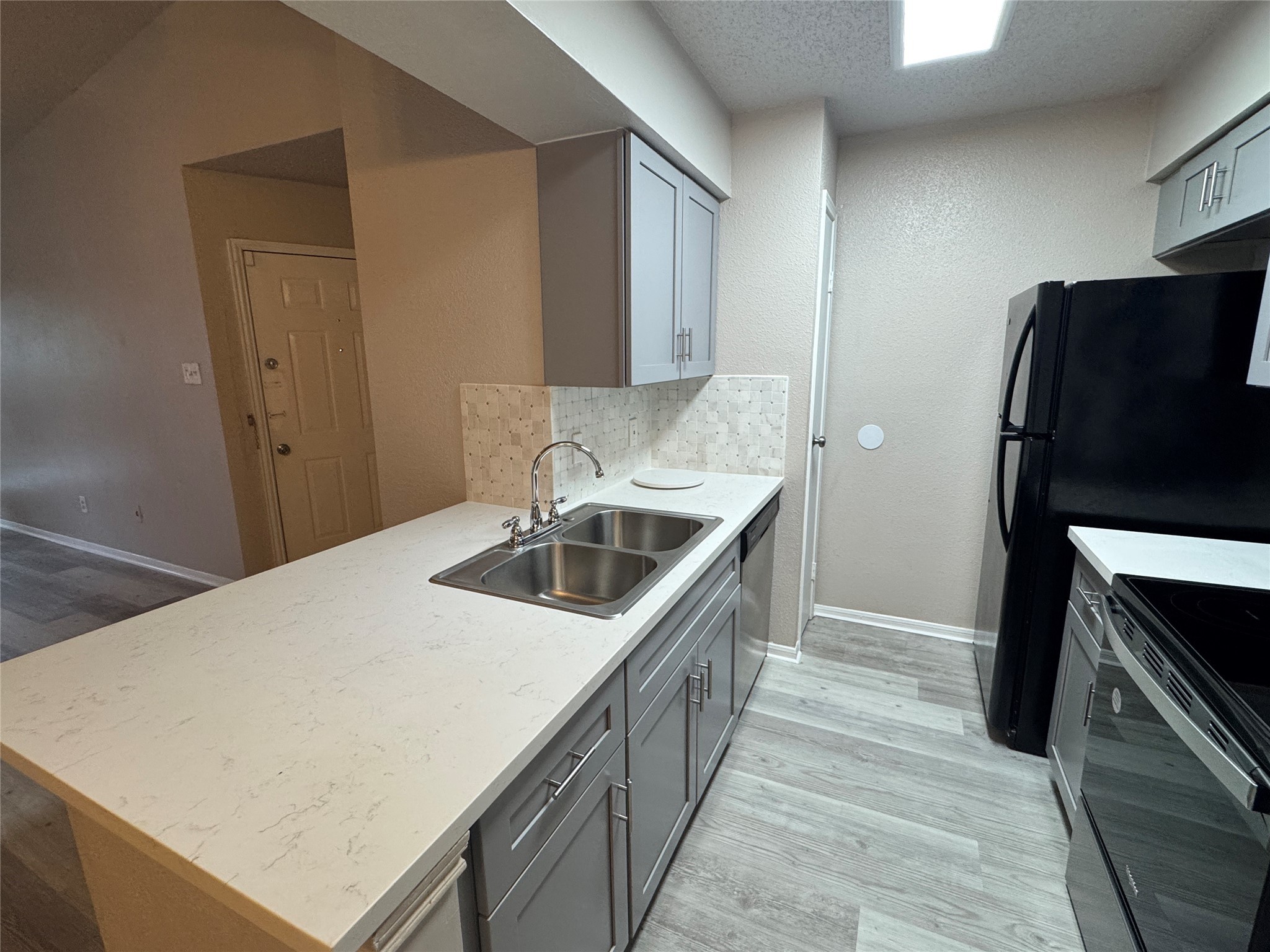 10101 South Gessner Road, Unit 305 Houston, TX 77071 - Photo 6 of 18 a kitchen with stainless steel appliances a sink and a refrigerator